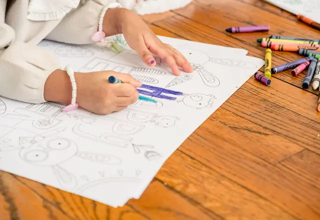 Child coloring inside the lines with a crayon